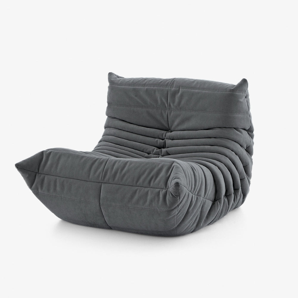 #Gris Koto Mini chauffeuse lounge compressée 1 place coloris gris, vue de profil : fauteuil bas au design 70s, assise ferme, velours matelassé, livré compressé