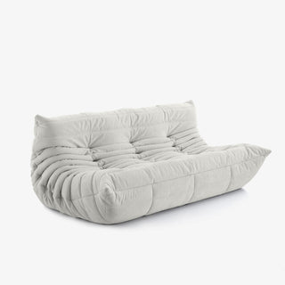#Blanc Koto canapé lounge compressé 3 places coloris blanc, vue de profil : assise ferme, silhouette années 70, velours matelassé, livré compressé dans un seul carton